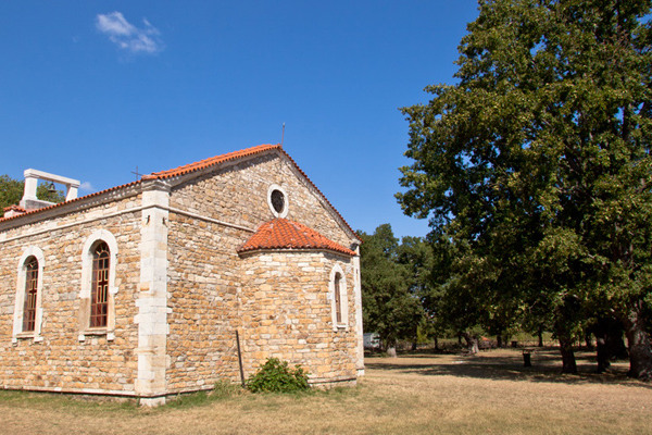 Η τούβλινη εκκλησία της Αγίας Παρασκευής περιτριγυρισμένη από δέντρα.