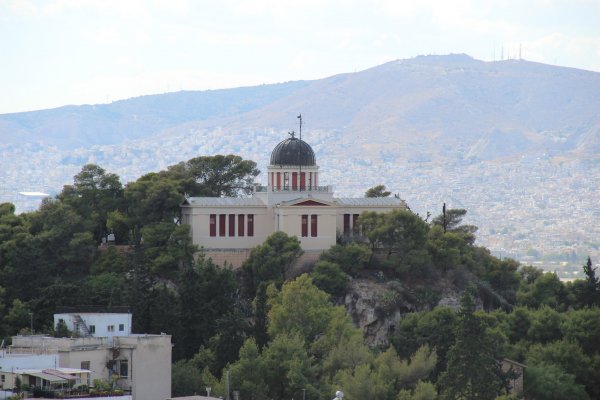 Το Εθνικό Αστεροσκοπείο Αθηνών είναι ένα κρεμ νεοκλασικό κτίριο με τρούλο μέσα στο δάσος.