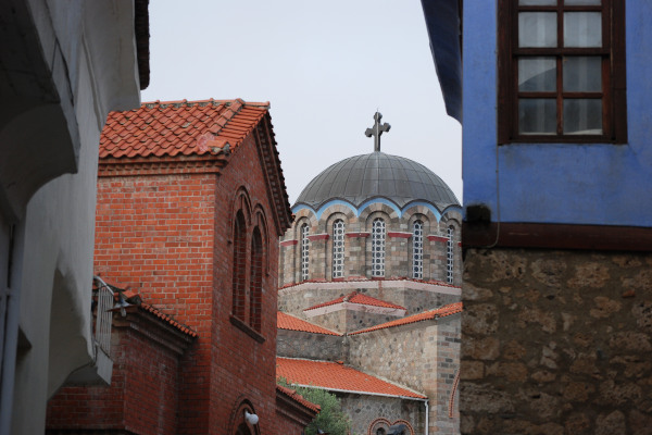 Ένας θόλος εκκλησίας μεταξύ κτιρίων στην περιοχή Βαρόσι στην Έδεσσα.