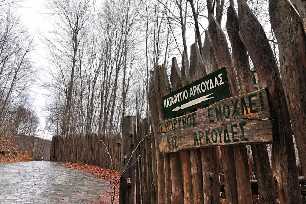 Ο ξύλινος φράχτης του καταφυγίου ανάμεσα σε ένα χειμερινό τοπίο, καθώς και πινακίδες.
